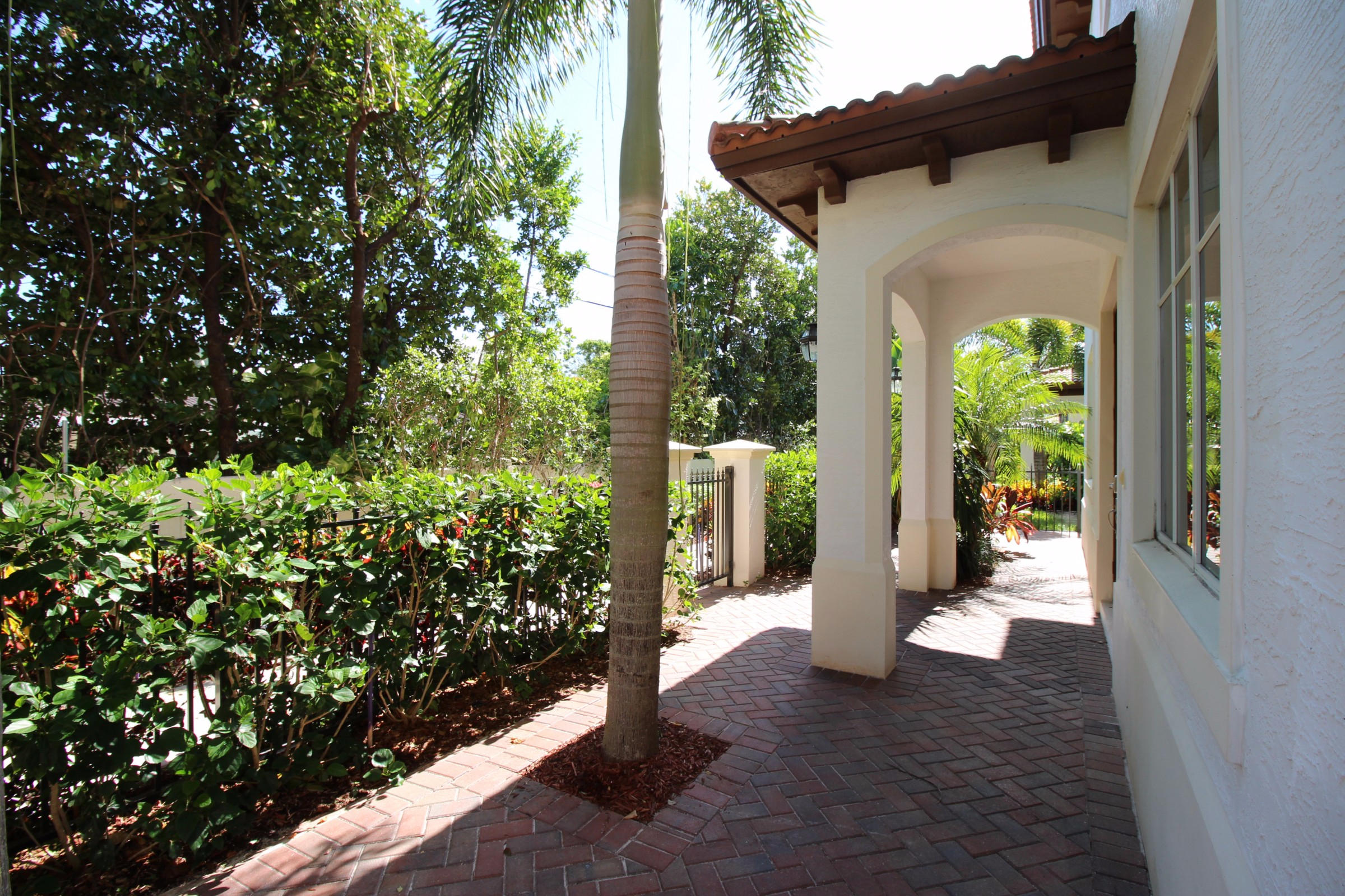 145 Northwest Emerson Place Boca Raton, FL 33432 - Photo 3 of 35 a view of a pathway of the house and a yard