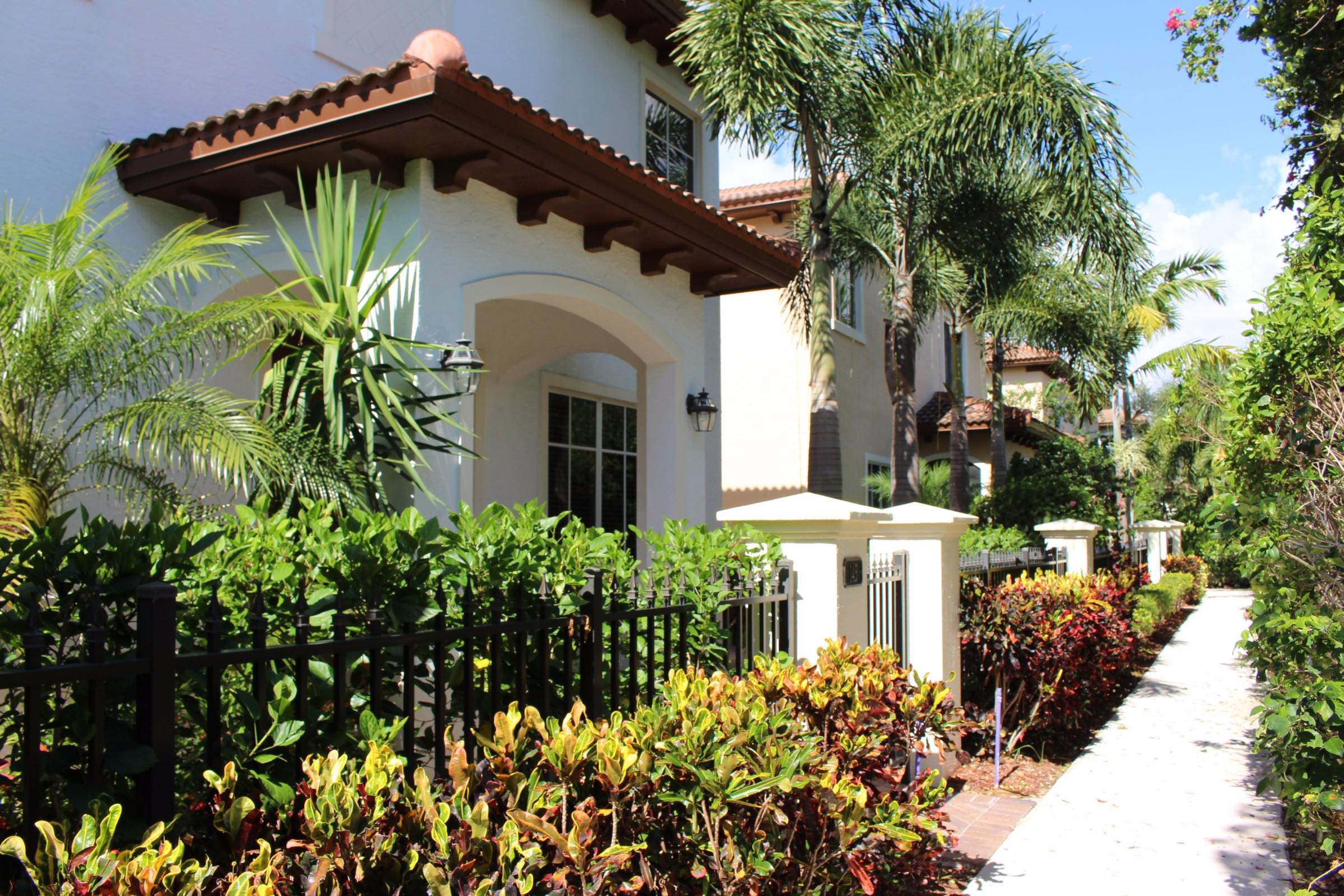 145 Northwest Emerson Place Boca Raton, FL 33432 - Photo 4 of 35 a view of a house with a flower garden