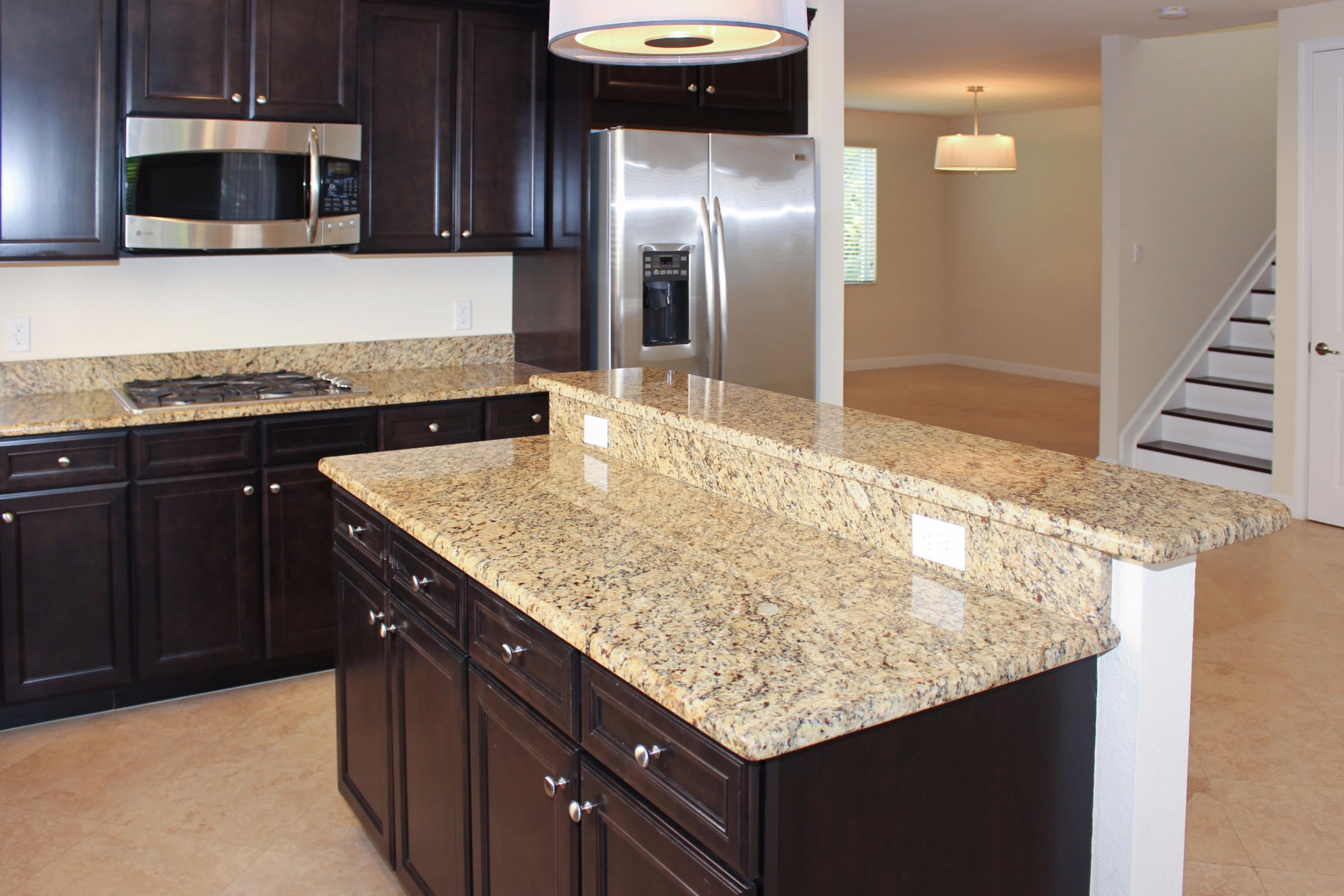 145 Northwest Emerson Place Boca Raton, FL 33432 - Photo 7 of 35 a kitchen with stainless steel appliances granite countertop a sink and a microwave