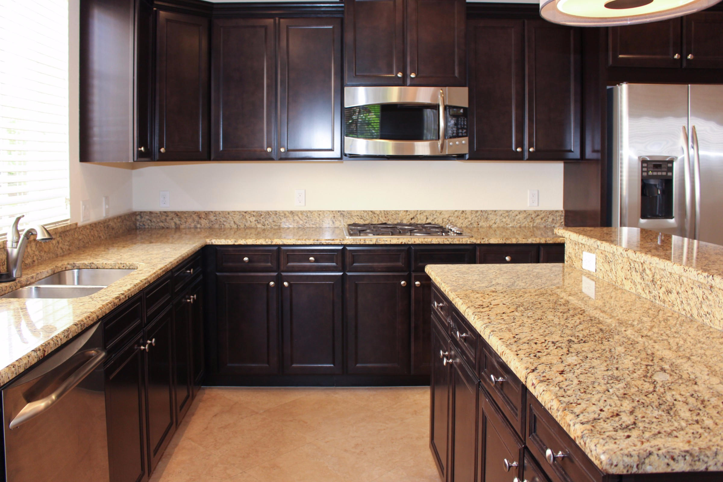145 Northwest Emerson Place Boca Raton, FL 33432 - Photo 8 of 35 a kitchen with granite countertop wooden cabinets and stainless steel appliances