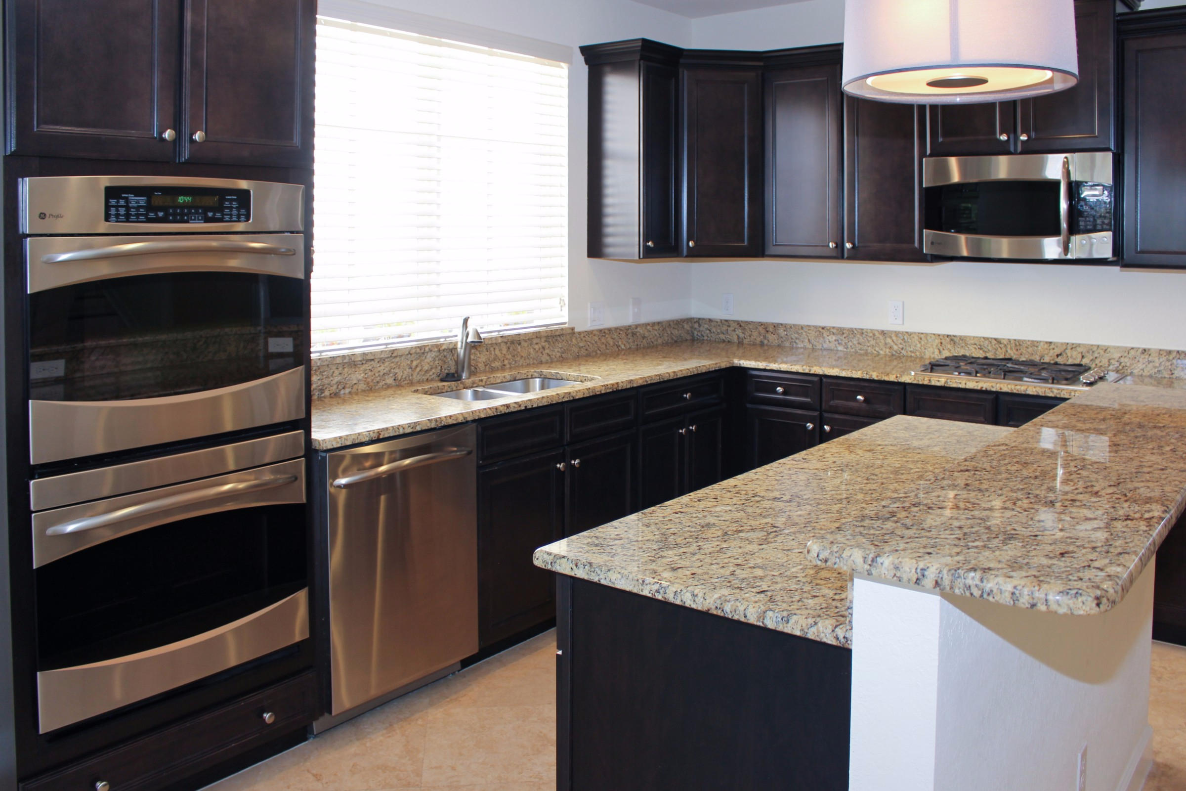 145 Northwest Emerson Place Boca Raton, FL 33432 - Photo 9 of 35 a kitchen with a sink and a stove