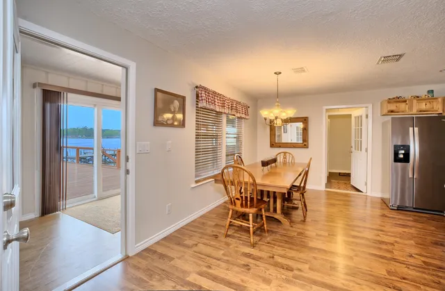 an empty room with window and ceiling fan