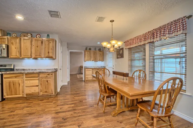 an aerial view of a residential houses with outdoor space and parking