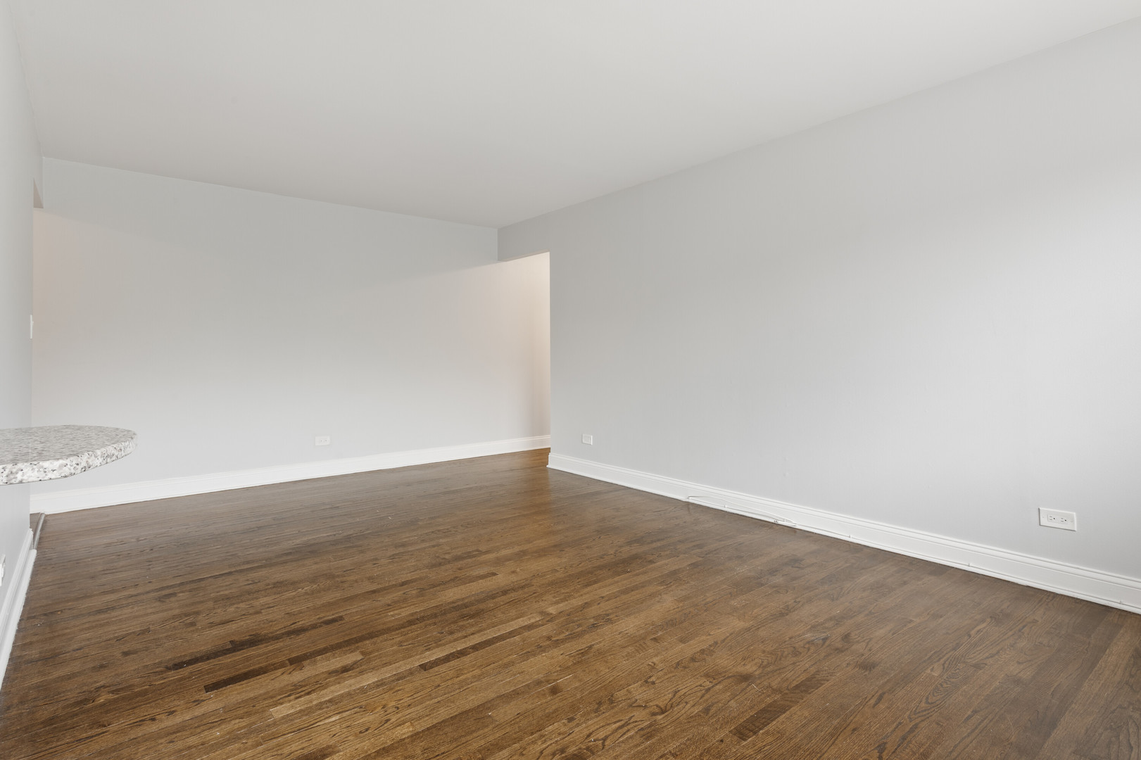 6826 North Ridge Boulevard, Unit 401 Chicago, IL 60645 - Photo 3 of 16 a view of an empty room and wooden floor