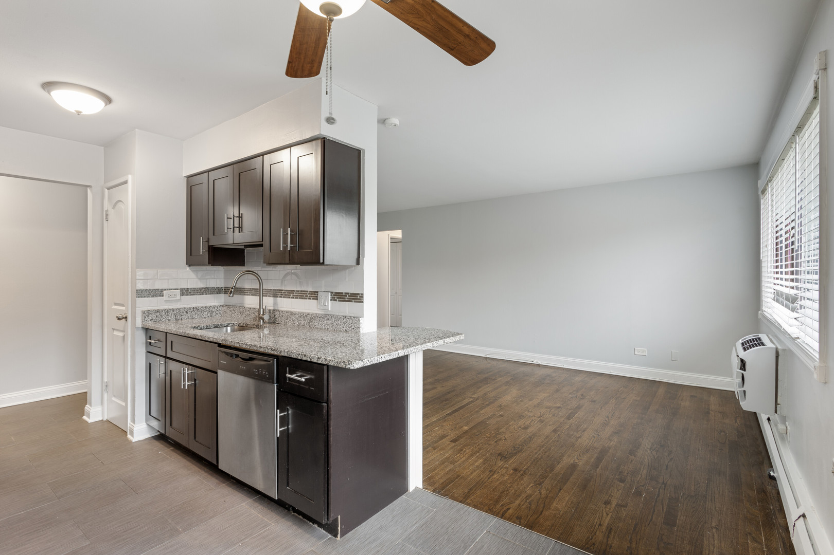 6826 North Ridge Boulevard, Unit 401 Chicago, IL 60645 - Photo 4 of 16 a kitchen with stainless steel appliances granite countertop a sink and a stove