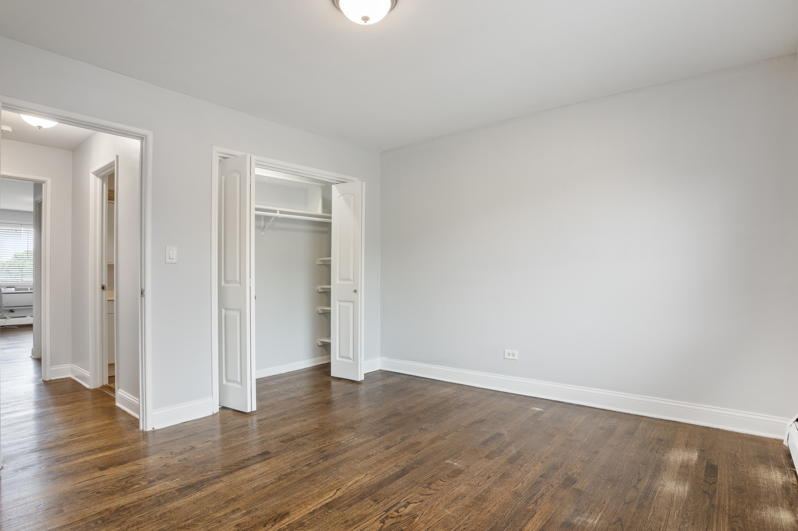 6826 North Ridge Boulevard, Unit 401 Chicago, IL 60645 - Photo 9 of 16 a view of an empty room and wooden floor