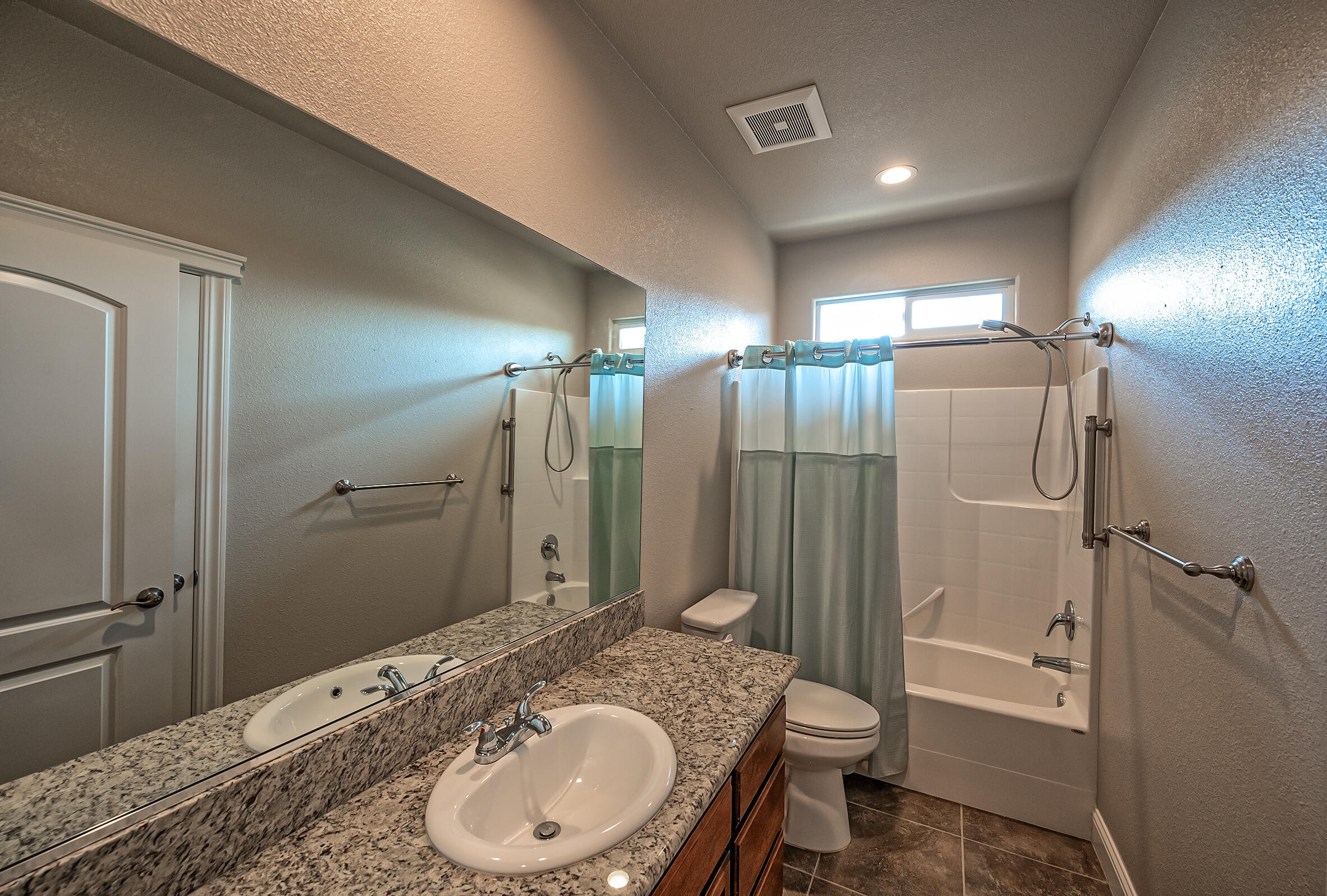 3375 Hotlam Road Redding, CA 96002 - Photo 23 of 38 a bathroom with a granite countertop sink toilet and shower