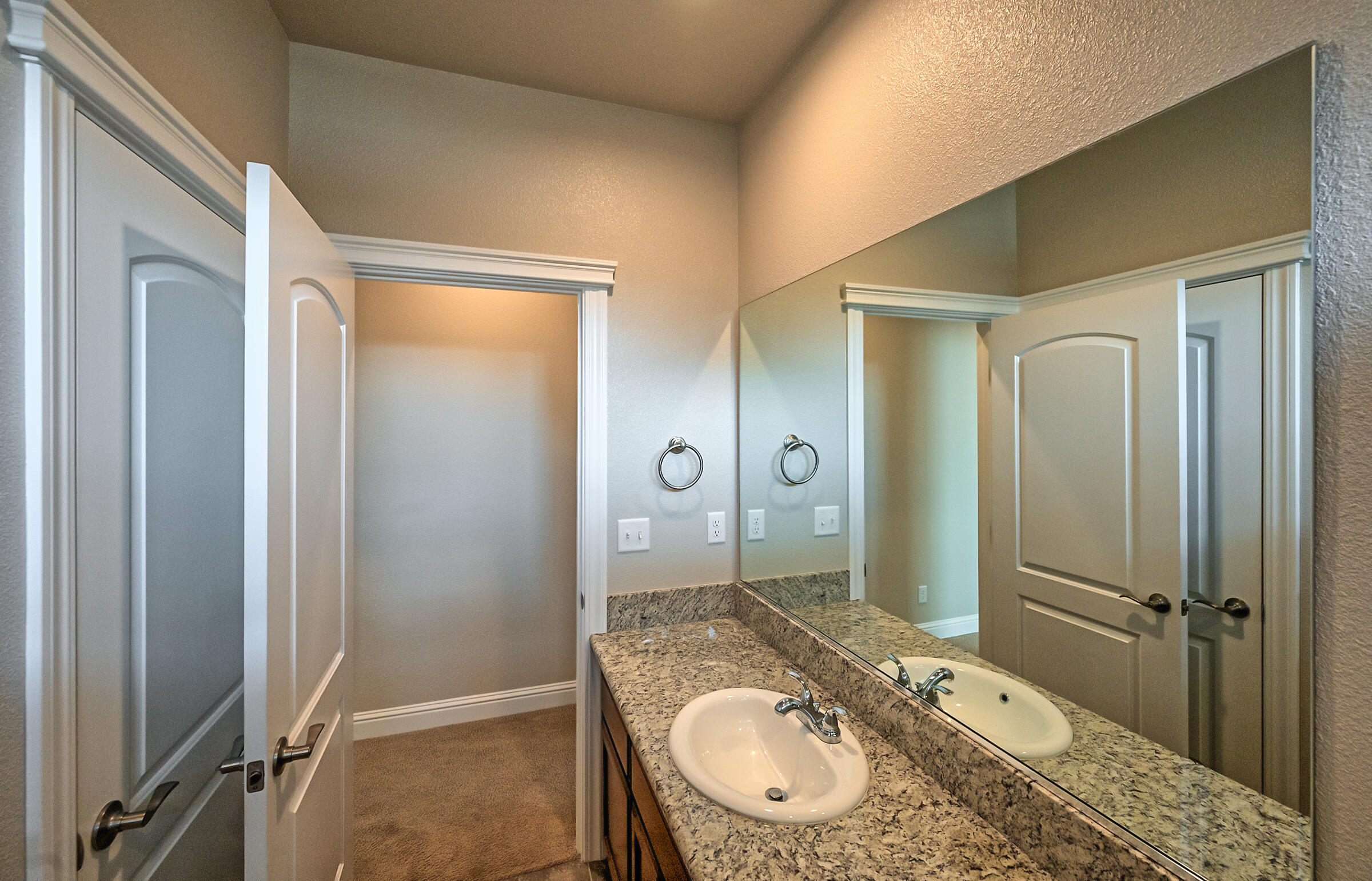 3375 Hotlam Road Redding, CA 96002 - Photo 24 of 38 a bathroom with a granite countertop sink a mirror and a shower