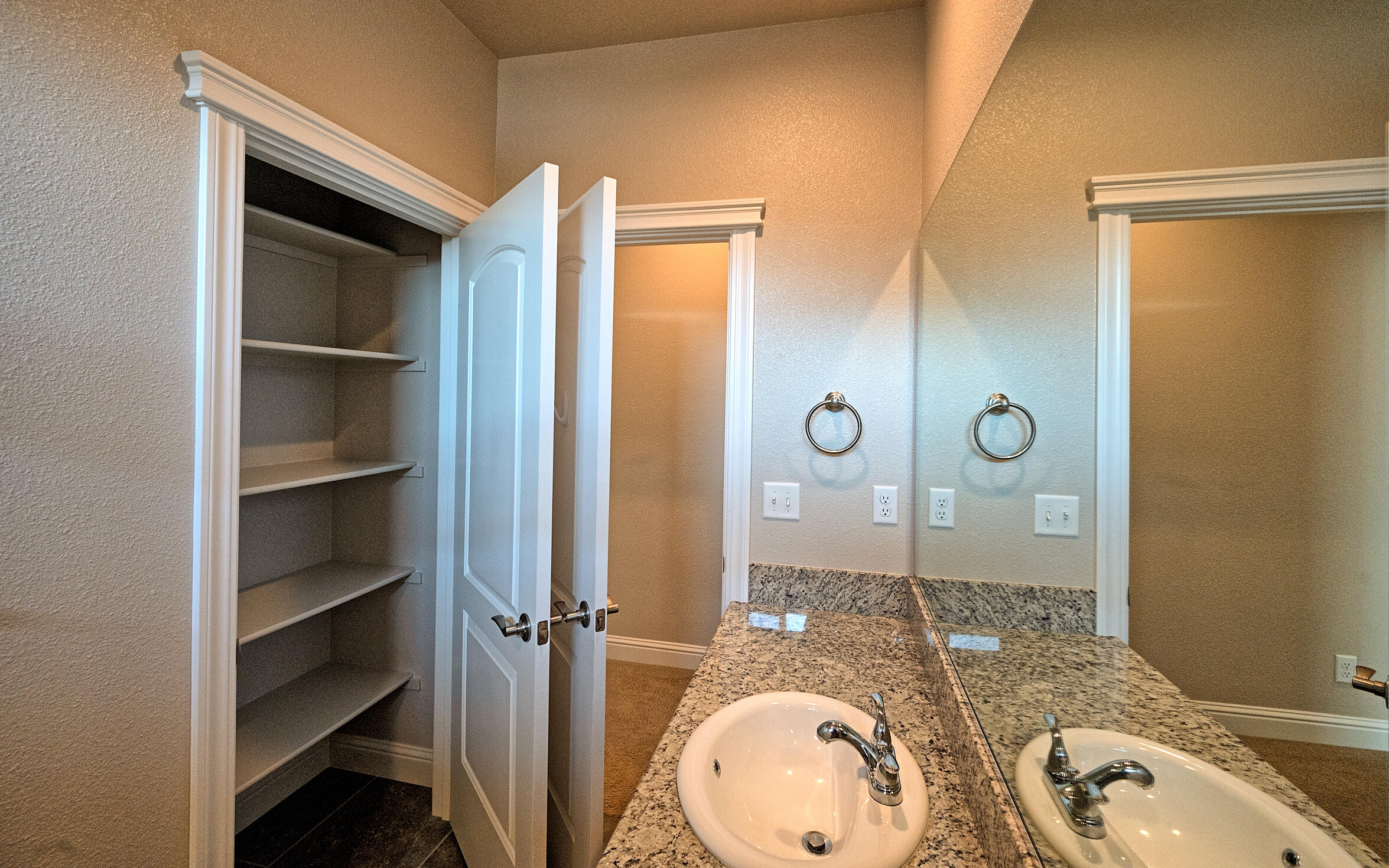 3375 Hotlam Road Redding, CA 96002 - Photo 25 of 38 a bathroom with a granite countertop sink mirror vanity and shower