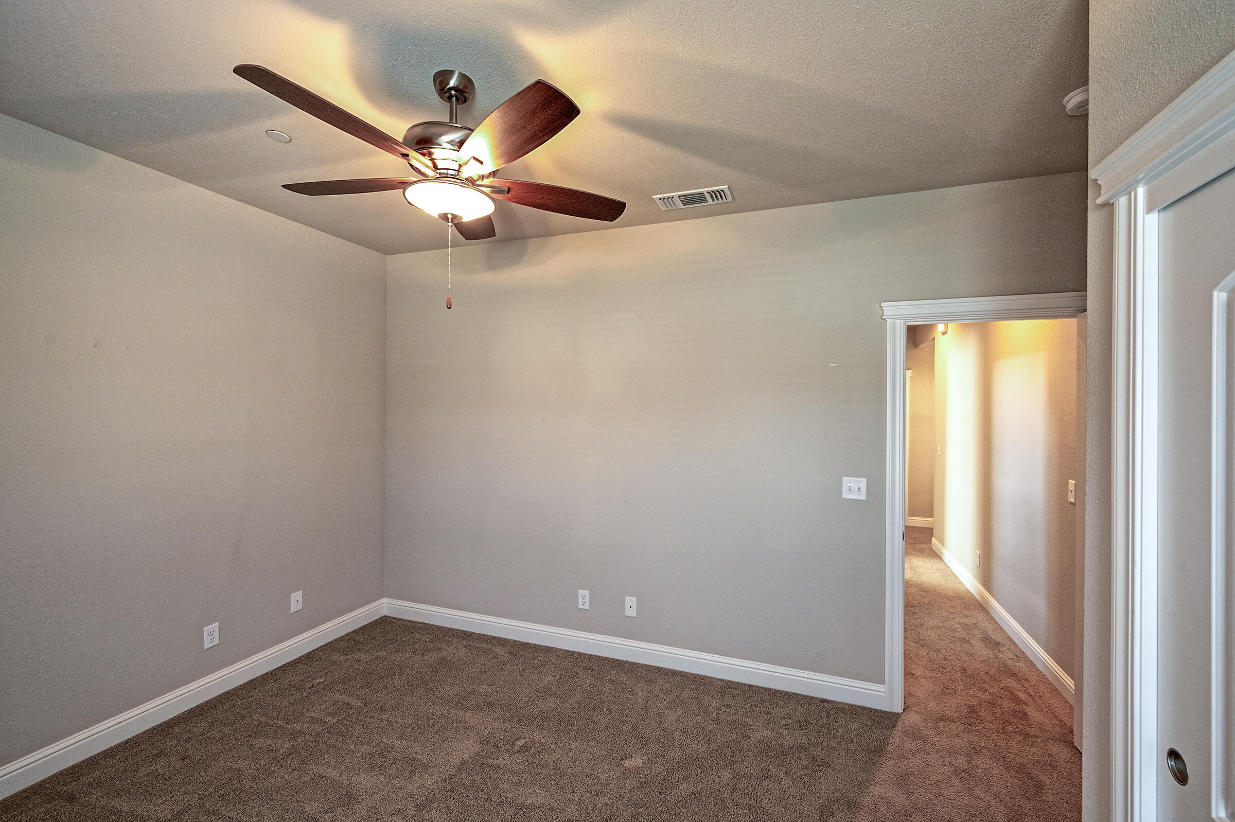 3375 Hotlam Road Redding, CA 96002 - Photo 28 of 38 an empty room with closet and a chandelier fan