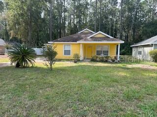 1527 Northeast 40th Place Gainesville, FL 32609 - Photo 2 of 19 a front view of a house with a yard