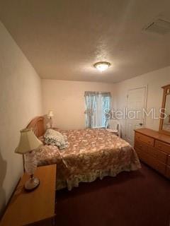 1527 Northeast 40th Place Gainesville, FL 32609 - Photo 8 of 19 a bedroom with a bed and a dresser