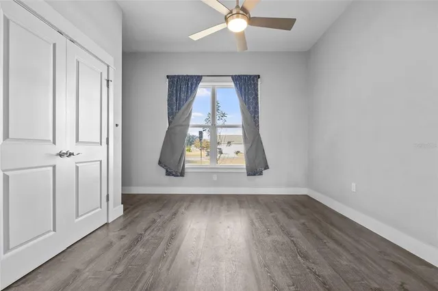 a view of wooden floor and windows in a room