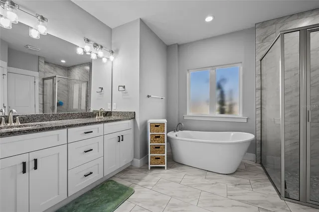 a white bath tub sitting next to a shower