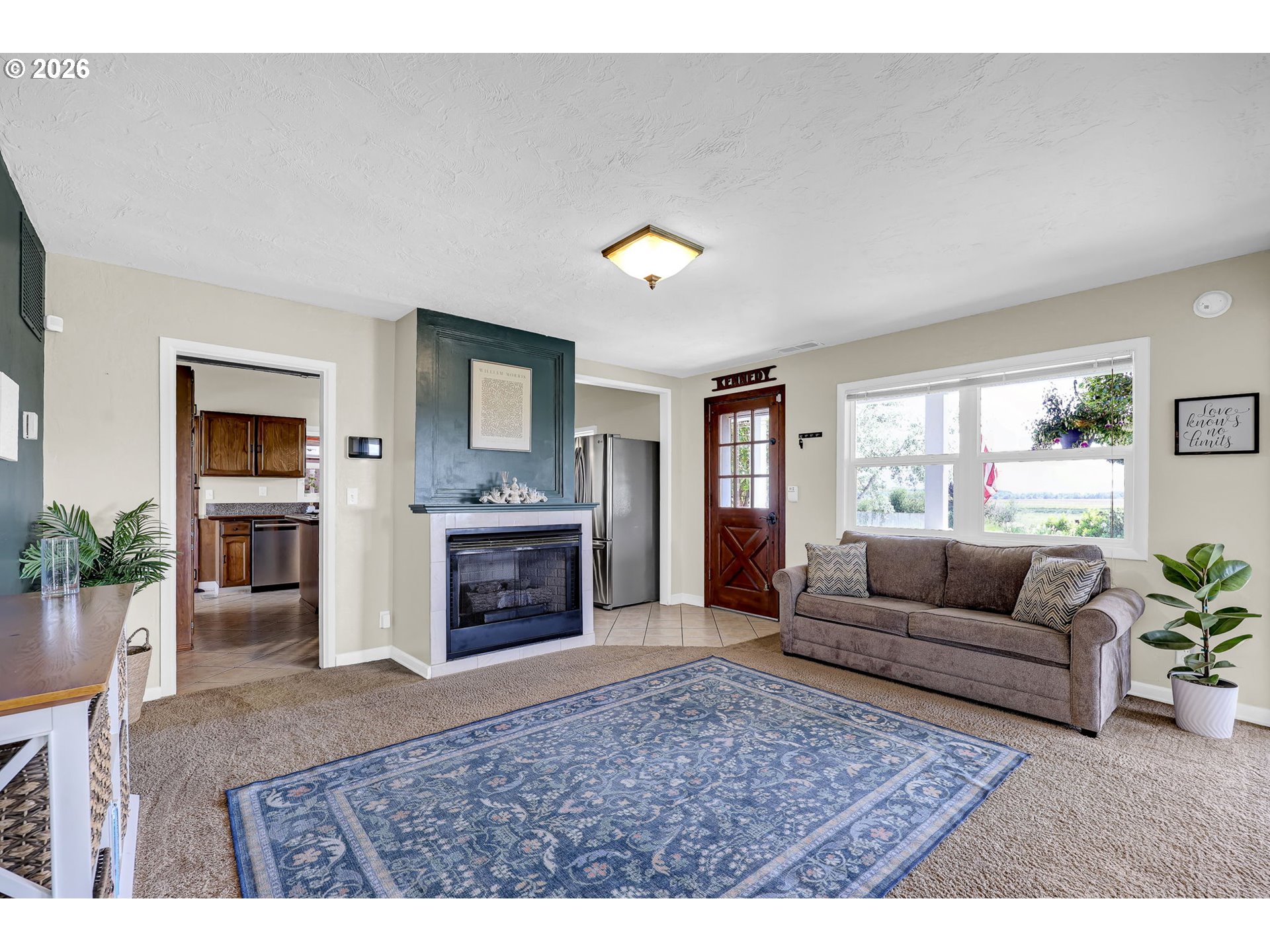 90440 Goodman Road Junction City, OR 97448 - Photo 6 of 48 a living room with furniture a fireplace and a flat screen tv
