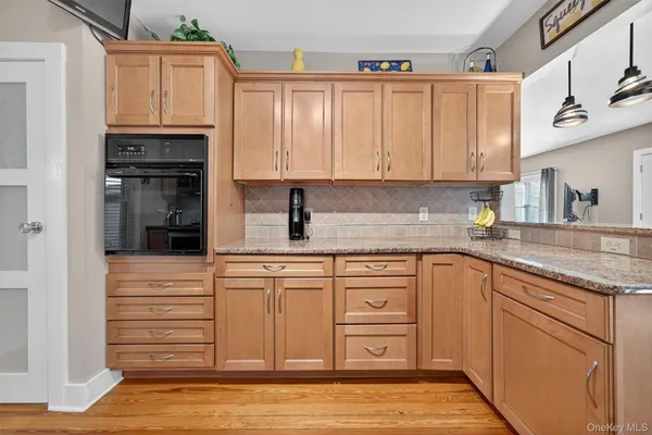 a kitchen with stainless steel appliances granite countertop a refrigerator and cabinets