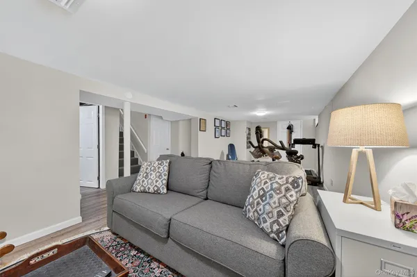 a living room with furniture and a lamp