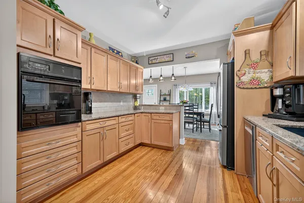 a kitchen with stainless steel appliances granite countertop a stove and cabinets