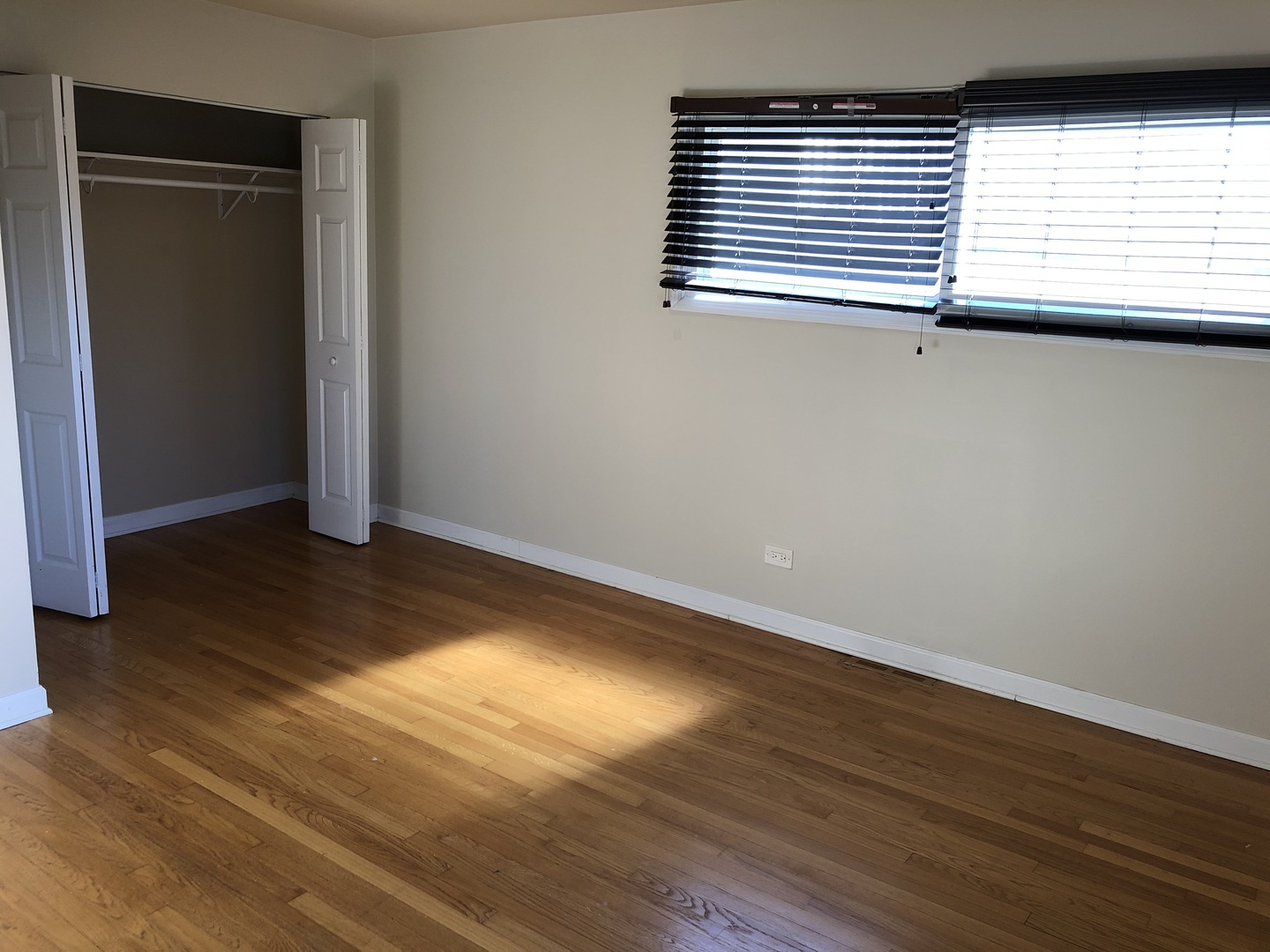 1674 Maple Street Des Plaines, IL 60018 - Photo 19 of 28 an empty room with wooden floor and windows
