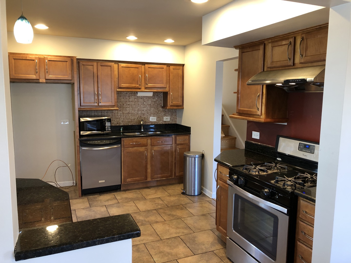 1674 Maple Street Des Plaines, IL 60018 - Photo 4 of 28 a kitchen with stainless steel appliances granite countertop a stove a sink and a refrigerator