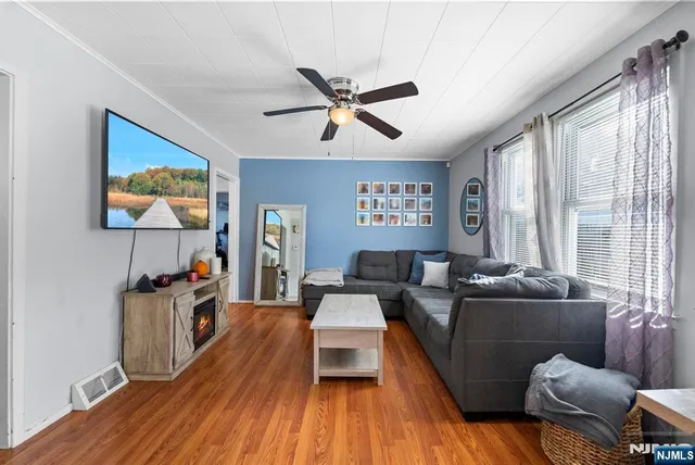 a living room with furniture and a flat screen tv