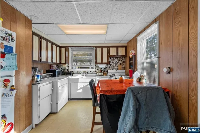 a large kitchen with a table and chairs