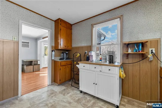 a kitchen with cabinets and a window