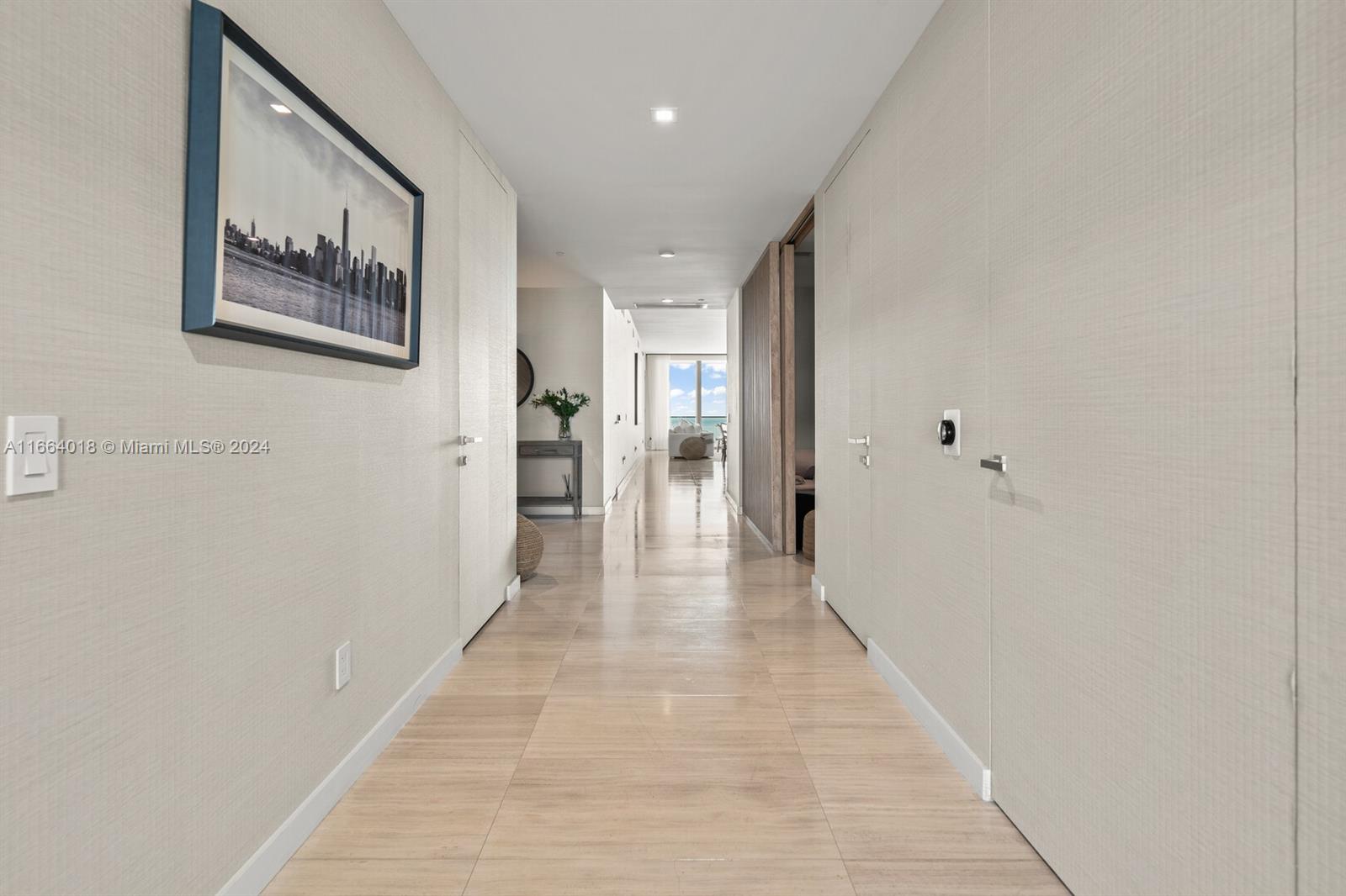 18975 Collins Avenue, Unit 5002 Sunny Isles Beach, FL 33160 - Photo 13 of 37 a hallway with wooden floor
