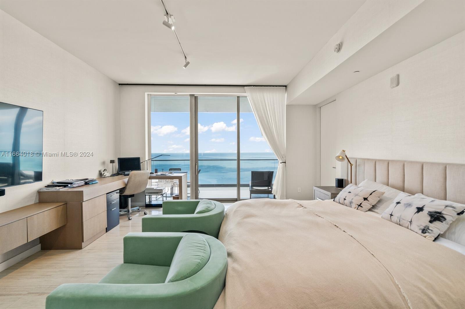 18975 Collins Avenue, Unit 5002 Sunny Isles Beach, FL 33160 - Photo 15 of 37 a bedroom with a bed and a large window