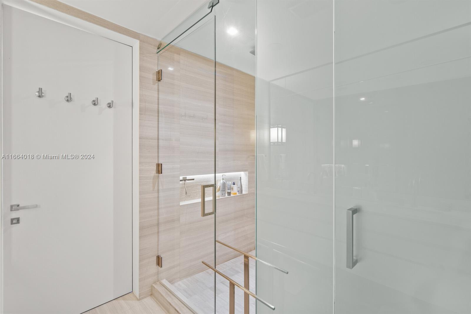 18975 Collins Avenue, Unit 5002 Sunny Isles Beach, FL 33160 - Photo 17 of 37 a bathroom with a glass shower door