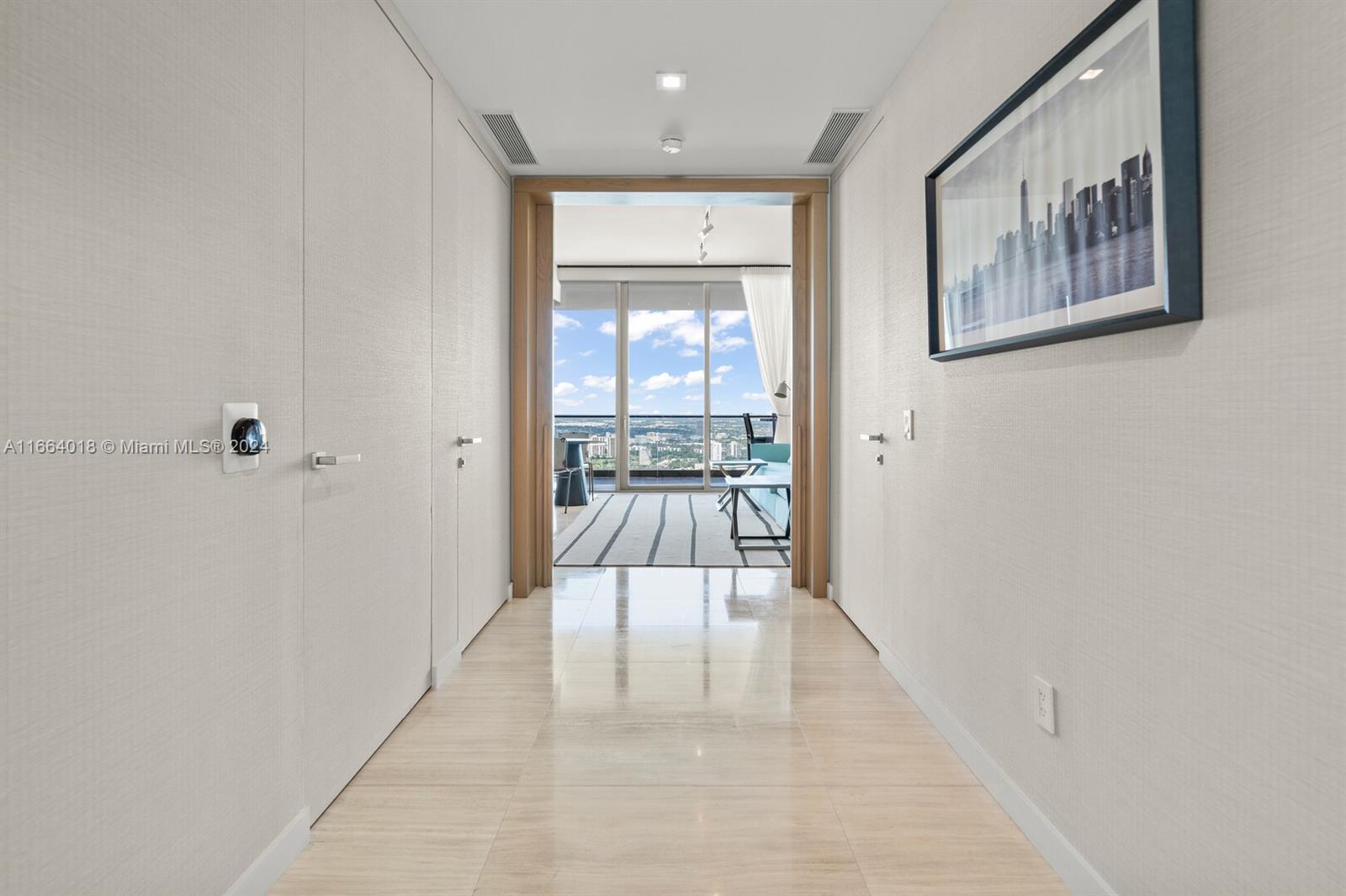 18975 Collins Avenue, Unit 5002 Sunny Isles Beach, FL 33160 - Photo 18 of 37 a view of a hallway with wooden floor and a bathroom