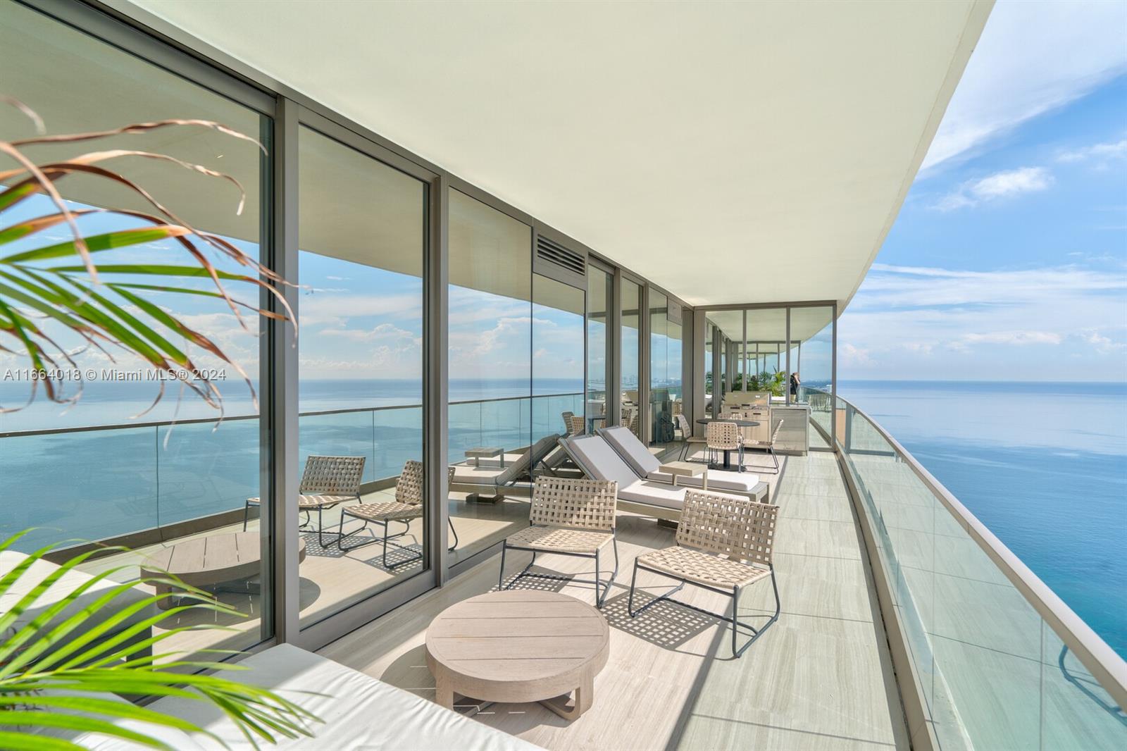 18975 Collins Avenue, Unit 5002 Sunny Isles Beach, FL 33160 - Photo 19 of 37 a living room with a floor to ceiling window and glass door