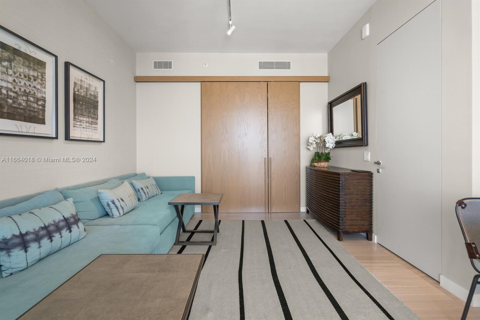 18975 Collins Avenue, Unit 5002 Sunny Isles Beach, FL 33160 - Photo 21 of 37 a living room with furniture and a rug