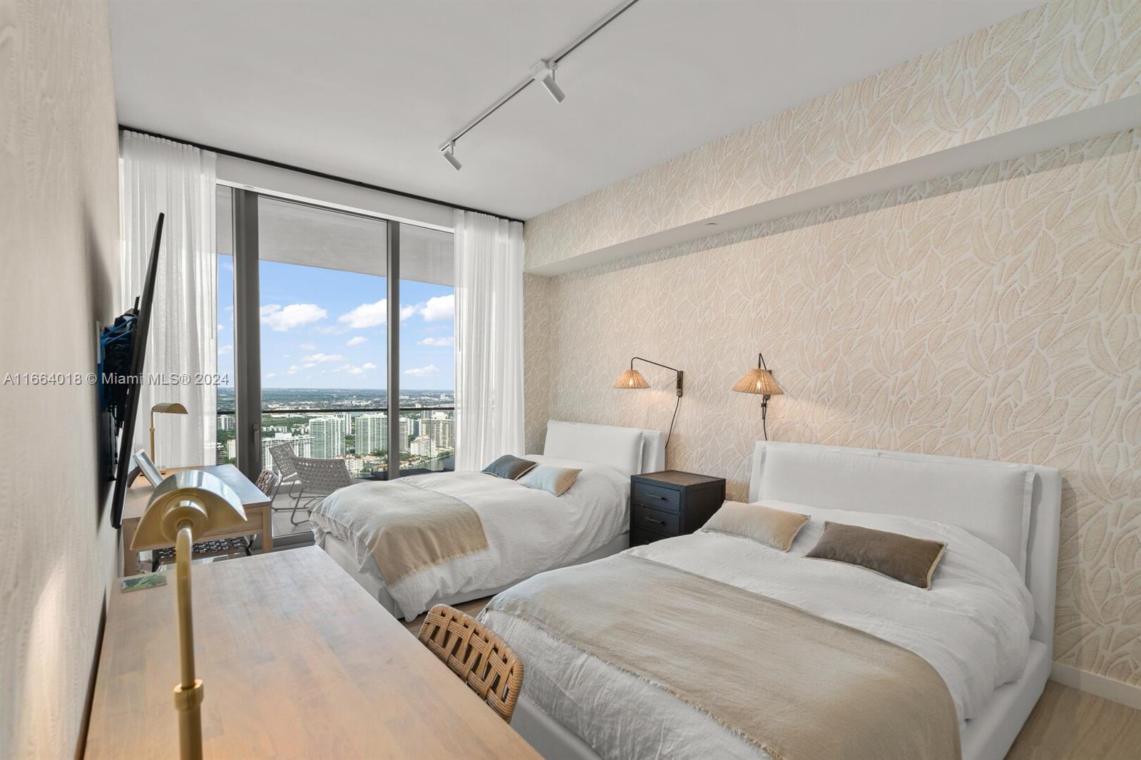 18975 Collins Avenue, Unit 5002 Sunny Isles Beach, FL 33160 - Photo 24 of 37 a bedroom with two beds and a large window