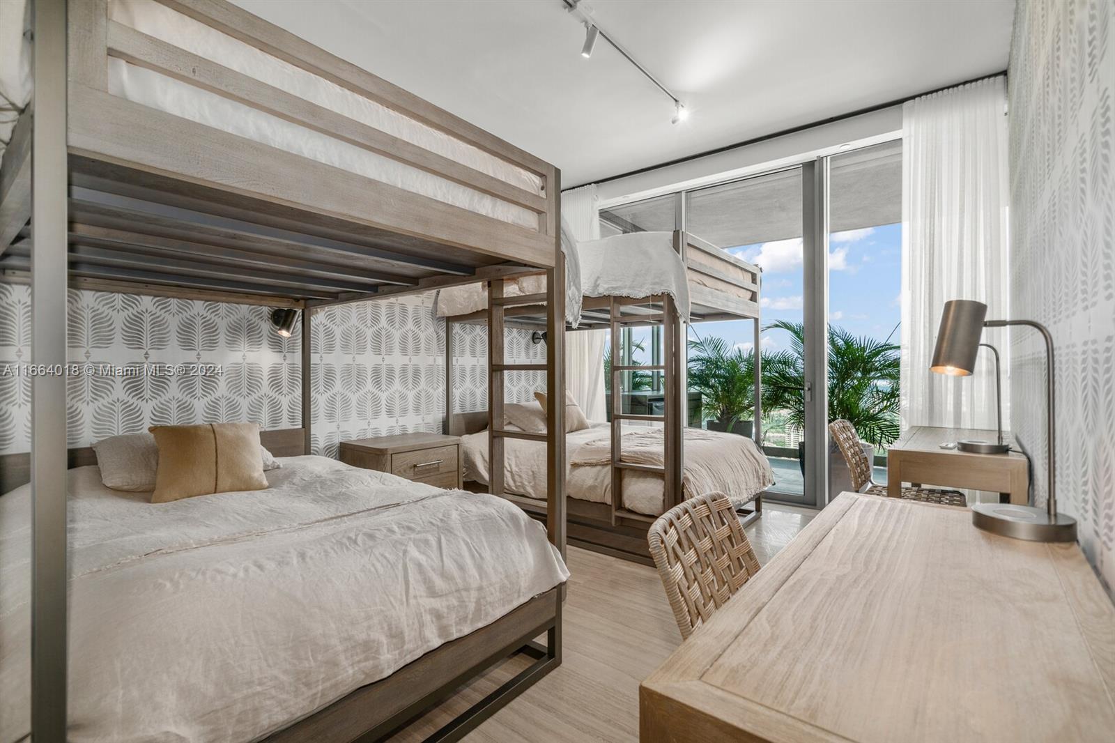18975 Collins Avenue, Unit 5002 Sunny Isles Beach, FL 33160 - Photo 27 of 37 a bedroom with a bed a large window with outer view and balcony view