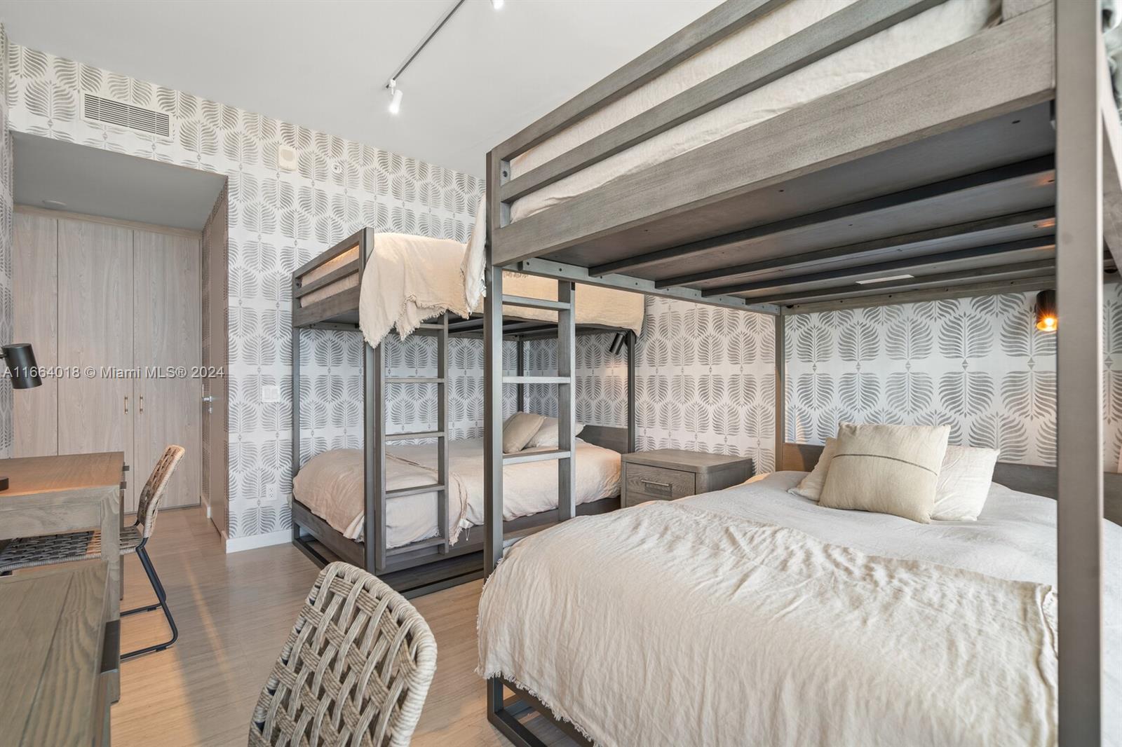 18975 Collins Avenue, Unit 5002 Sunny Isles Beach, FL 33160 - Photo 28 of 37 a bedroom with double bed and a chandelier