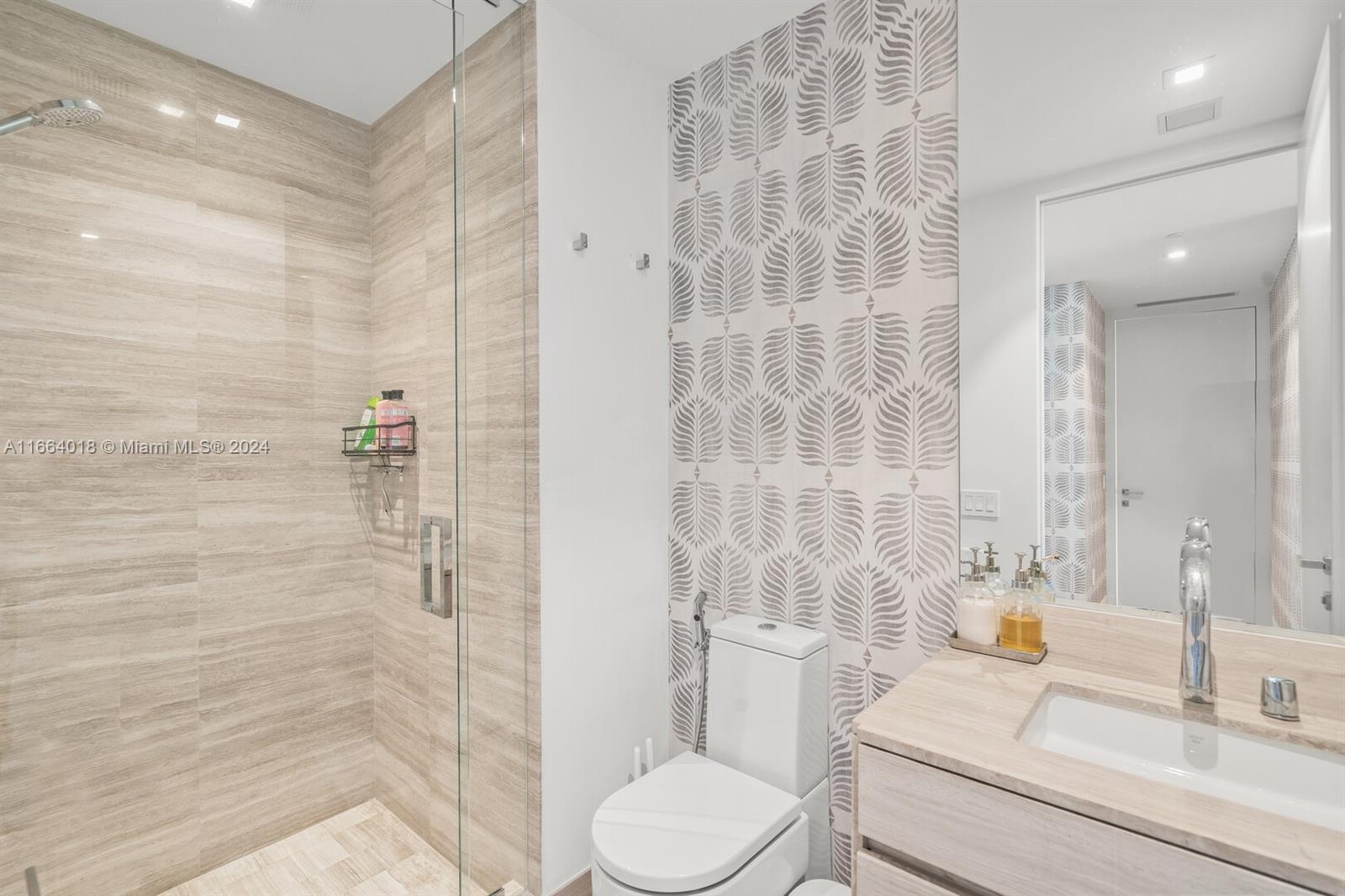 18975 Collins Avenue, Unit 5002 Sunny Isles Beach, FL 33160 - Photo 29 of 37 a bathroom with a sink toilet and shower