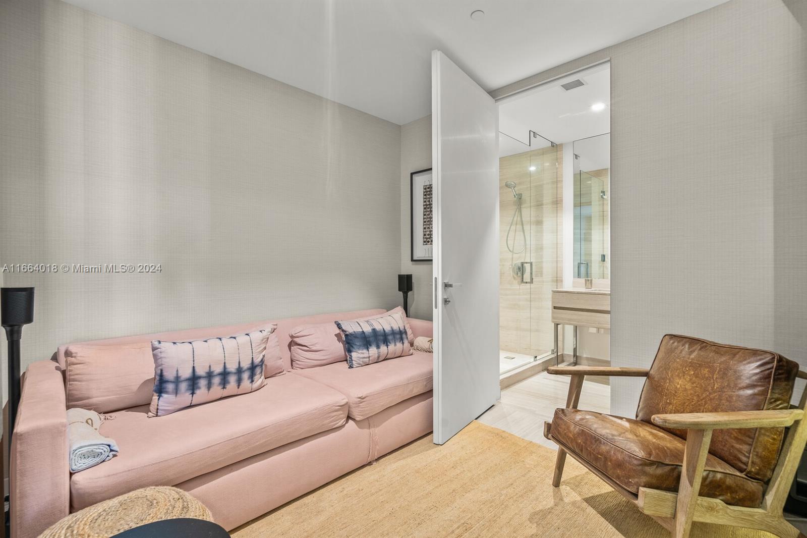 18975 Collins Avenue, Unit 5002 Sunny Isles Beach, FL 33160 - Photo 31 of 37 a living room with a couch and a table