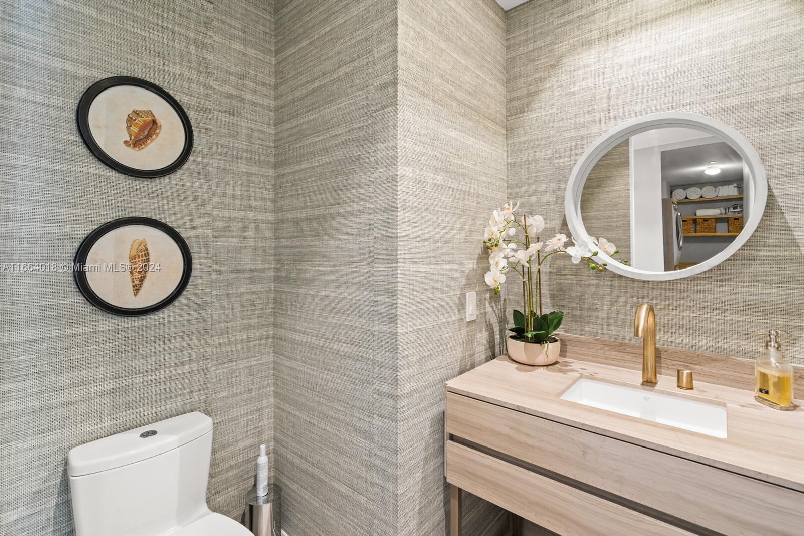 18975 Collins Avenue, Unit 5002 Sunny Isles Beach, FL 33160 - Photo 33 of 37 a bathroom with a toilet and a sink