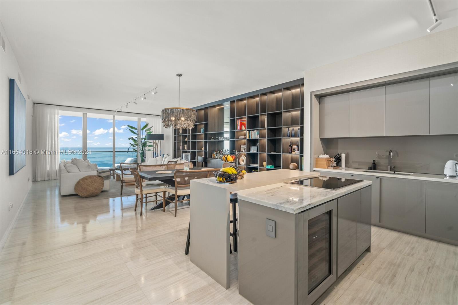 18975 Collins Avenue, Unit 5002 Sunny Isles Beach, FL 33160 - Photo 6 of 37 a kitchen with a sink stove and cabinets