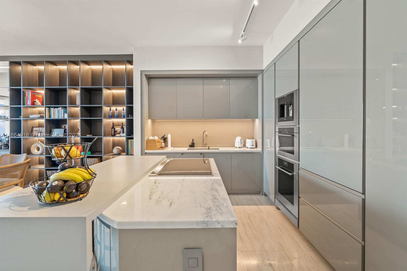 18975 Collins Avenue, Unit 5002 Sunny Isles Beach, FL 33160 - Photo 7 of 37 a kitchen with a sink and refrigerator