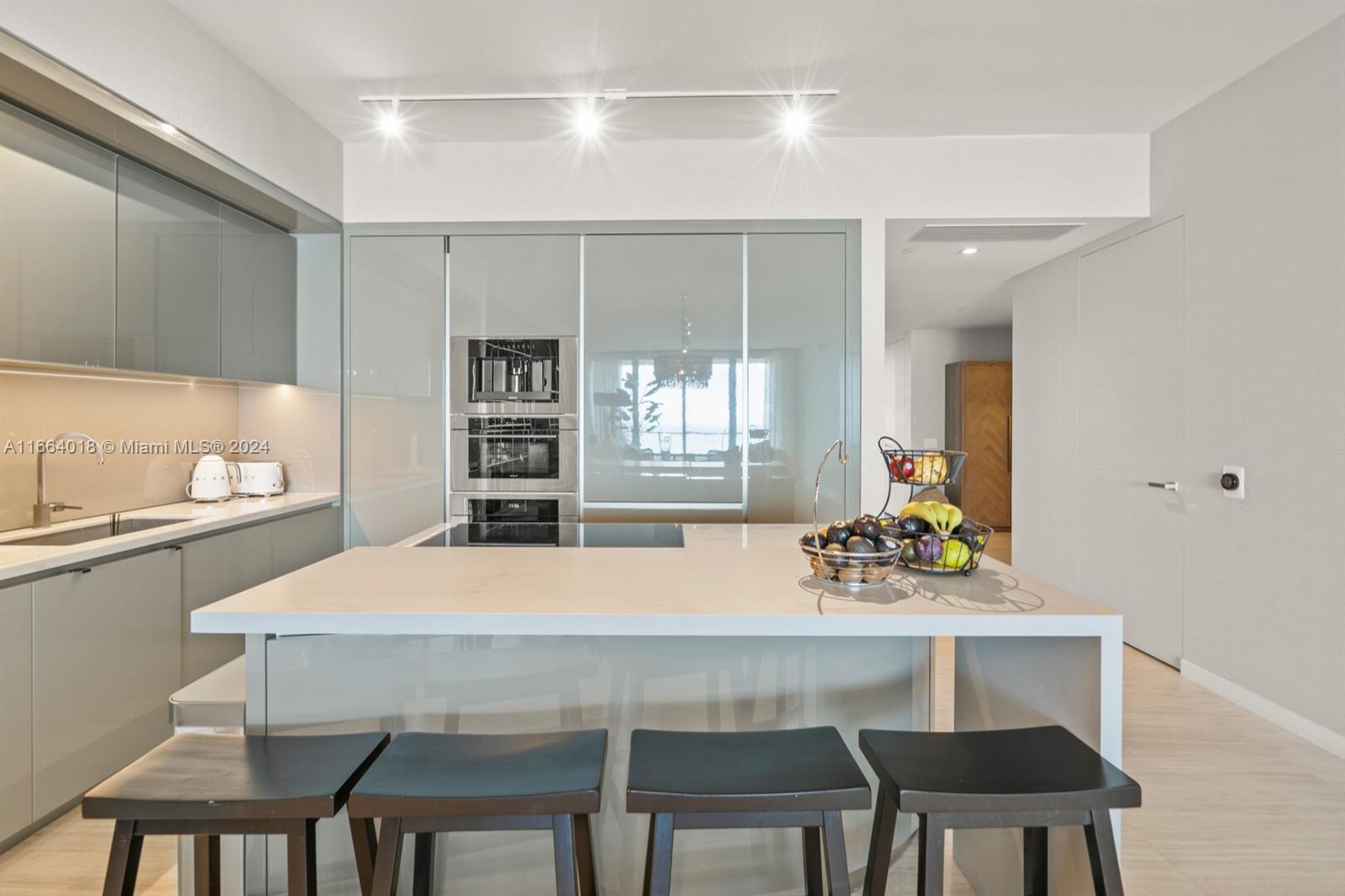 18975 Collins Avenue, Unit 5002 Sunny Isles Beach, FL 33160 - Photo 9 of 37 a dining room with a table chairs and chandelier