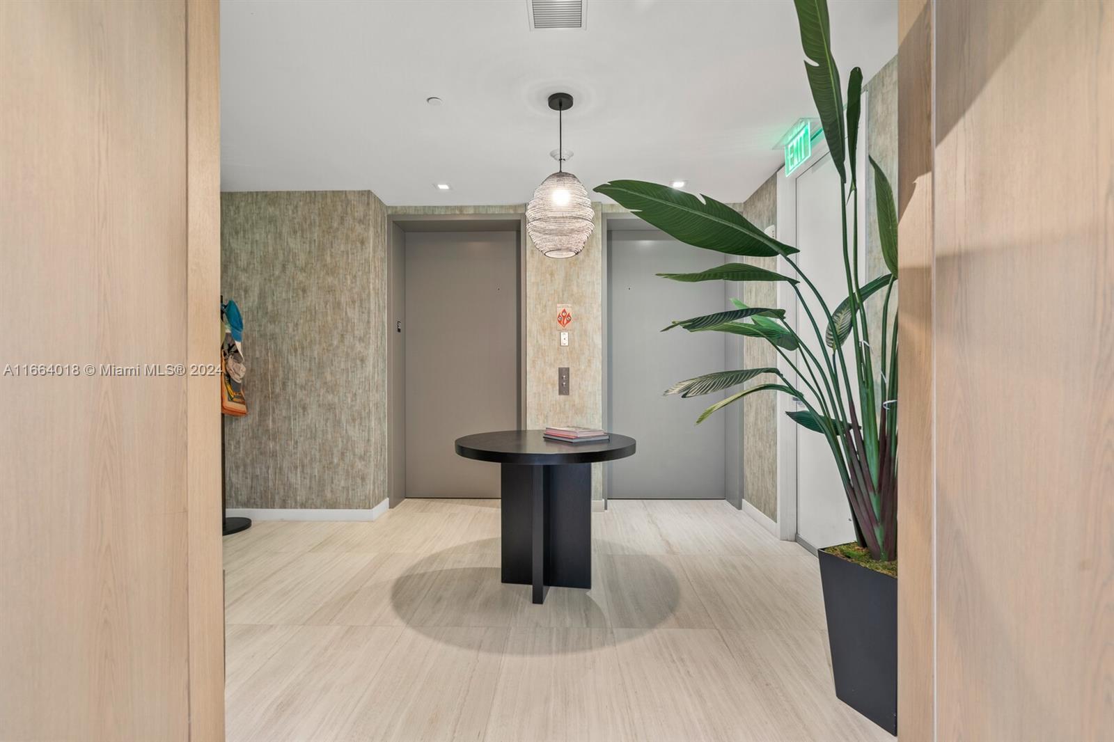 18975 Collins Avenue, Unit 5002 Sunny Isles Beach, FL 33160 - Photo 10 of 37 a vase of flowers sitting on a table