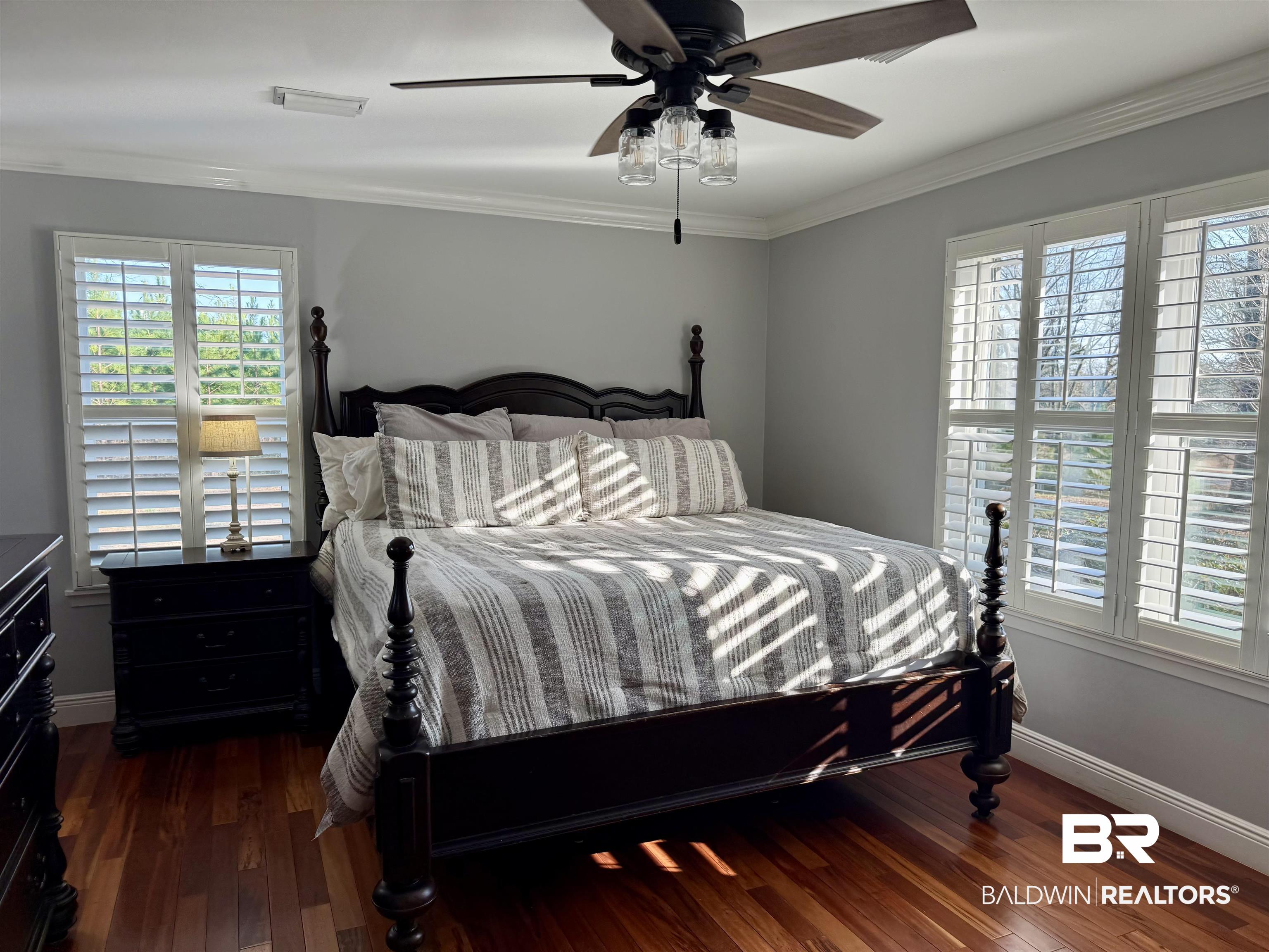 5646 Foshee Road Brewton, AL 36426 - Photo 12 of 37 Bedroom with dark wood-style flooring, ceiling fan, and ornamental molding