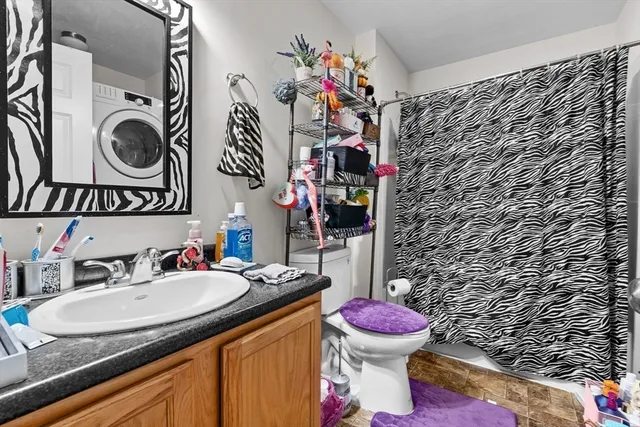 a bathroom with a sink toilet mirror and vanity