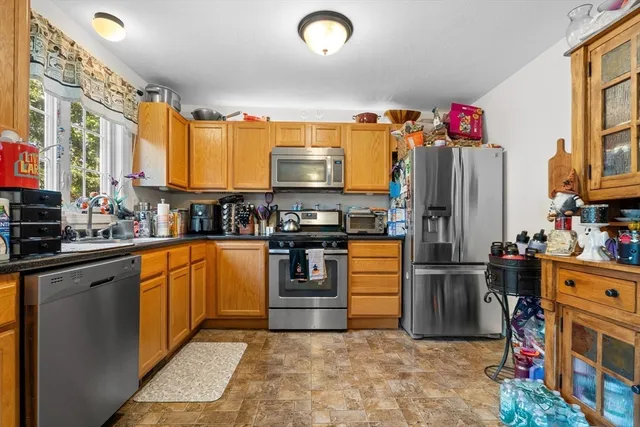 a kitchen with stainless steel appliances granite countertop a refrigerator stove and sink