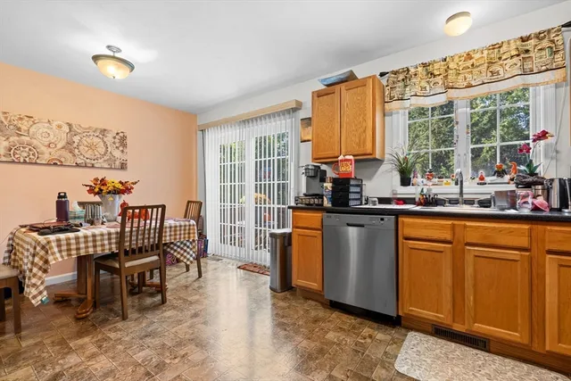 a dining room with furniture and a floor to ceiling window