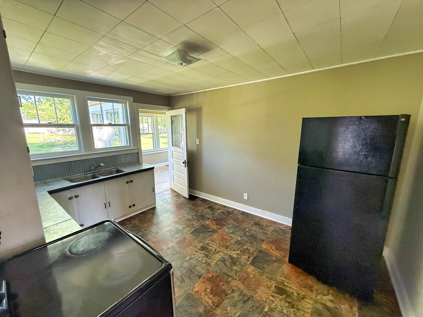 426 South Locust Street Flora, IL 62839 - Photo 15 of 58 a kitchen with a refrigerator and window