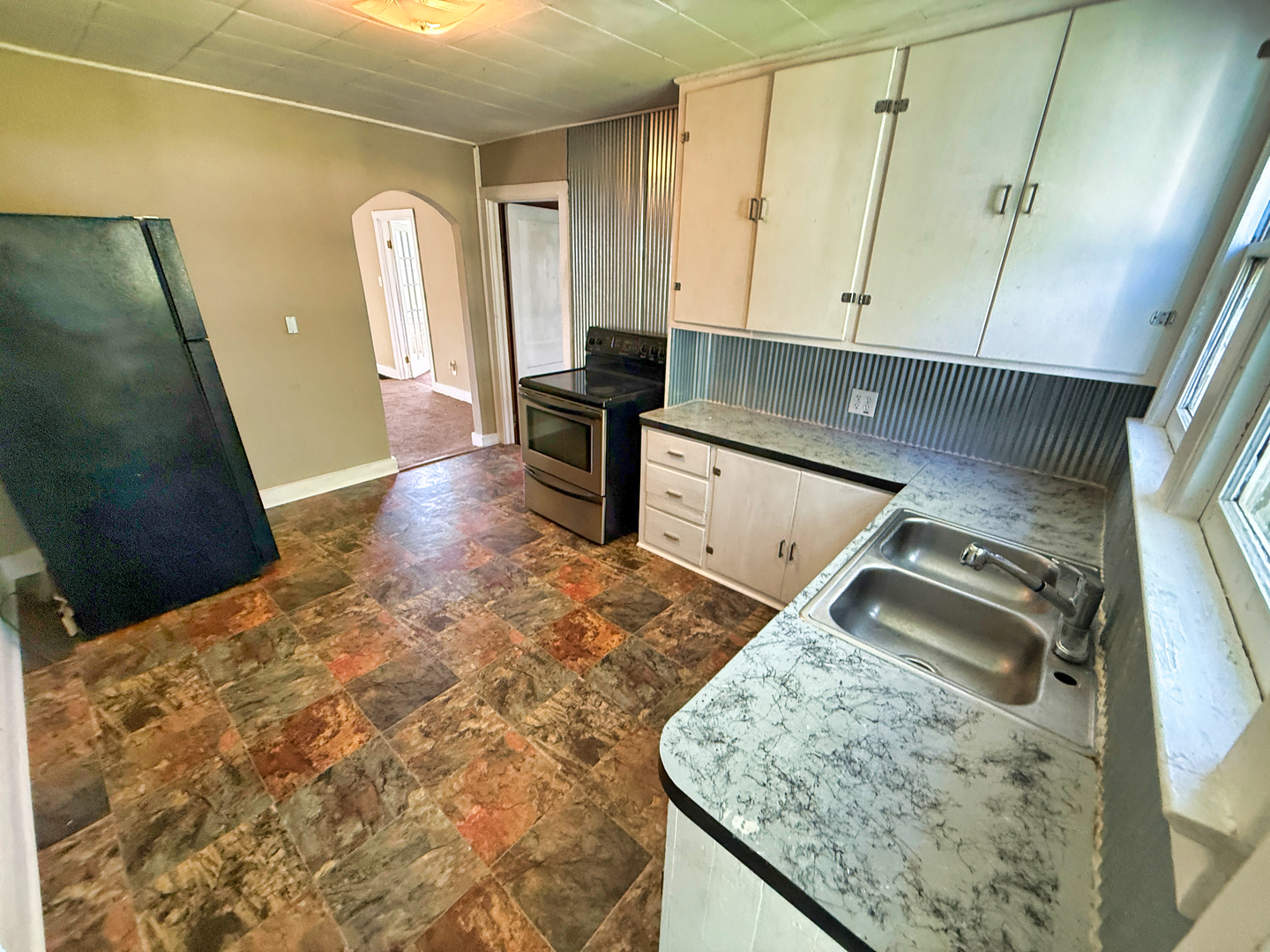 426 South Locust Street Flora, IL 62839 - Photo 16 of 58 a kitchen with a sink and a refrigerator