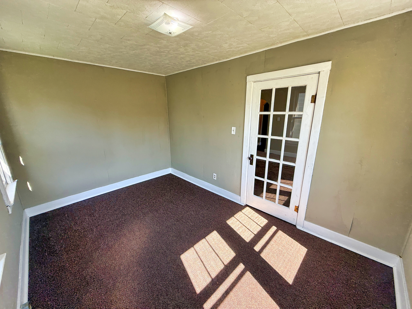 426 South Locust Street Flora, IL 62839 - Photo 21 of 58 an empty room with wooden floor and windows
